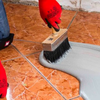 Priming for a tile over tile installation